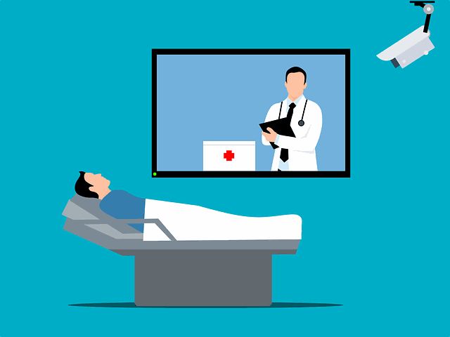 a graphic of a nurse on a screen assessing a patient in a hospital bed while they are monitored by a device on the wall